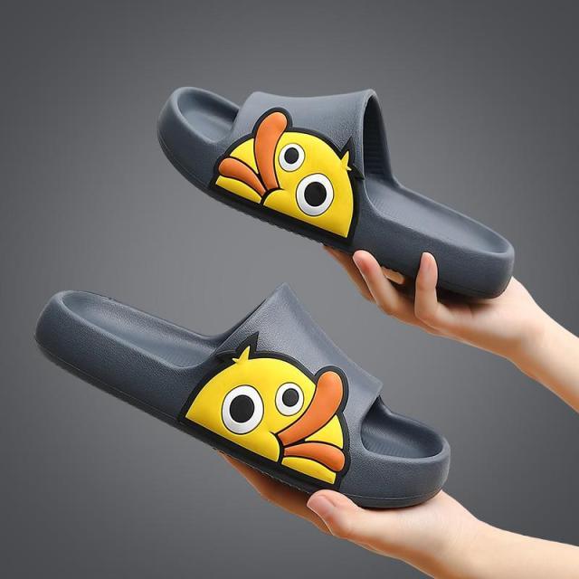 Gray slide sandals with cartoon character front graphic and open-toe design