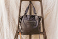 Black leather tote briefcase with top handles and front zipper pocket