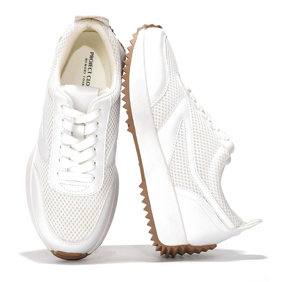 White lace-up sneakers, side view, with textured panels and chunky platform sole