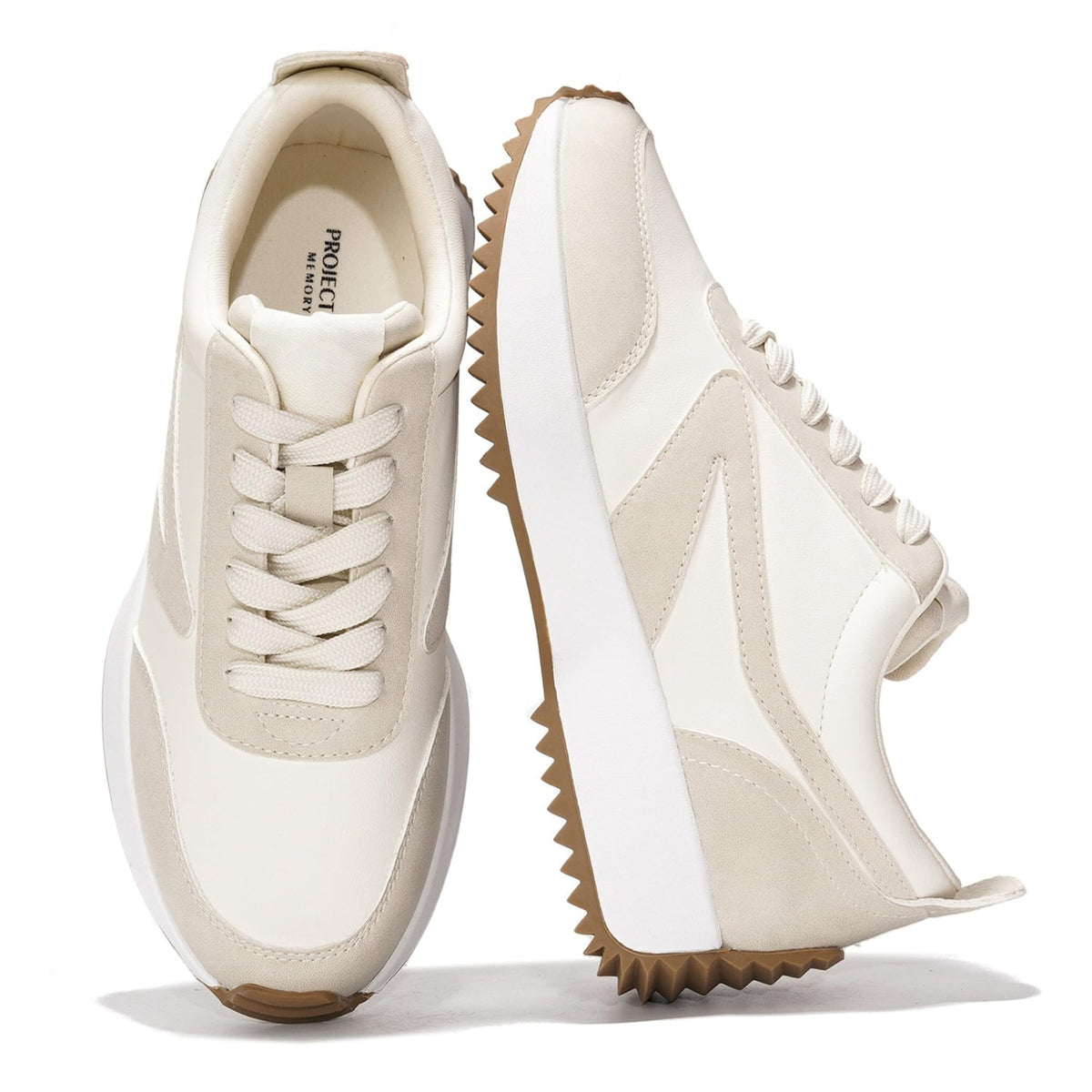 White lace-up sneakers with stitched overlays and chunky tread wedge sole