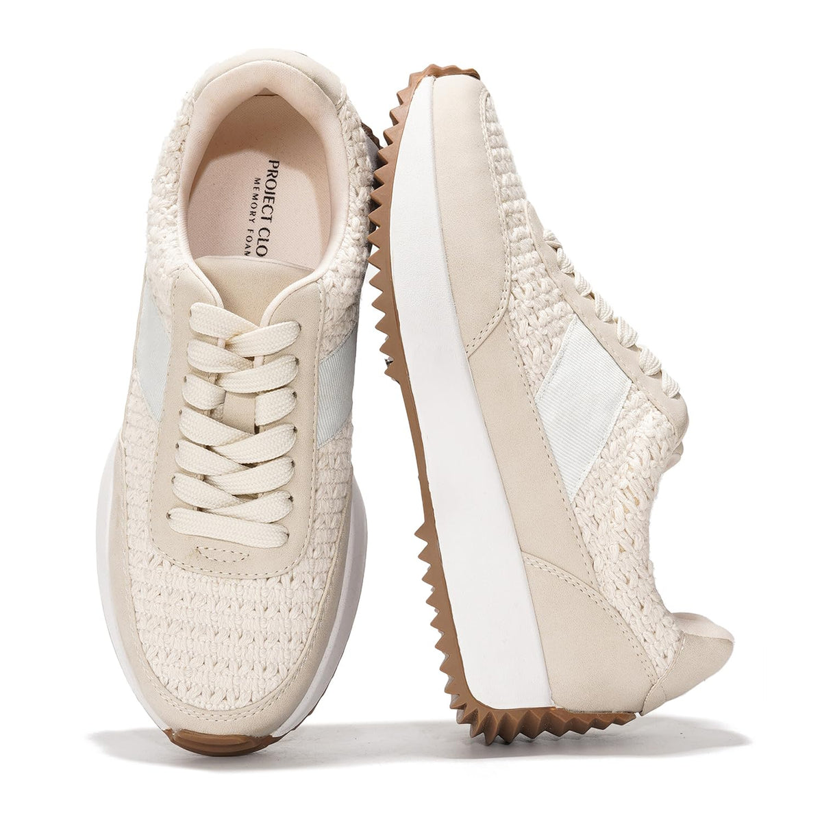 Cream lace-up sneakers with textured knit upper and chunky tread wedge sole