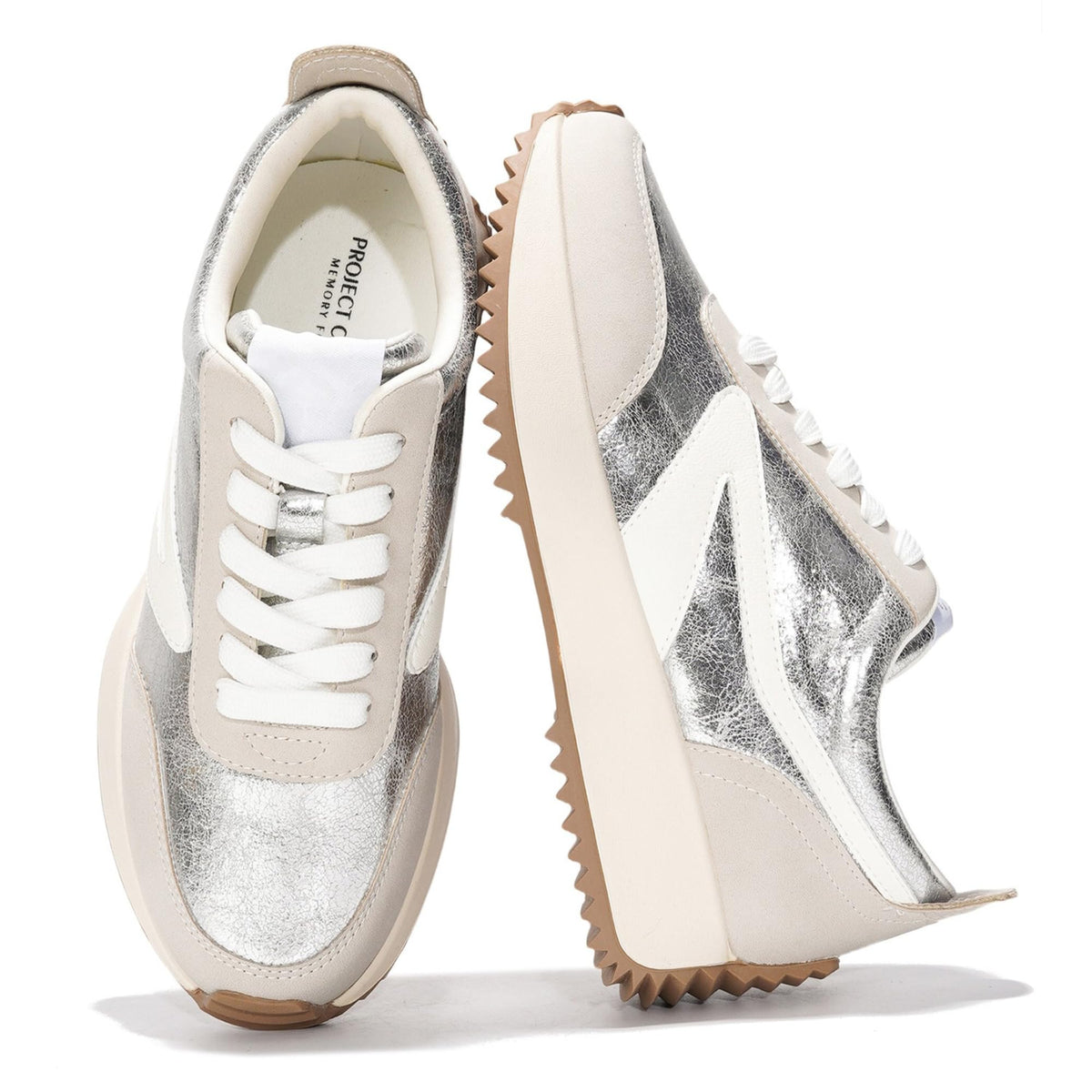 Silver and white lace-up sneakers with metallic panel accents and chunky tread wedge sole