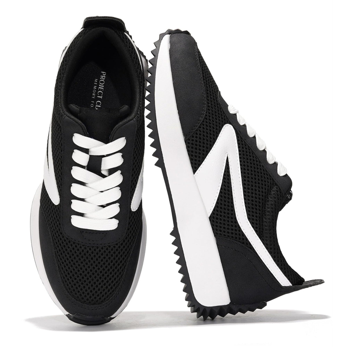 Black womens lace-up sneakers with white stripe accents and chunky tread sole