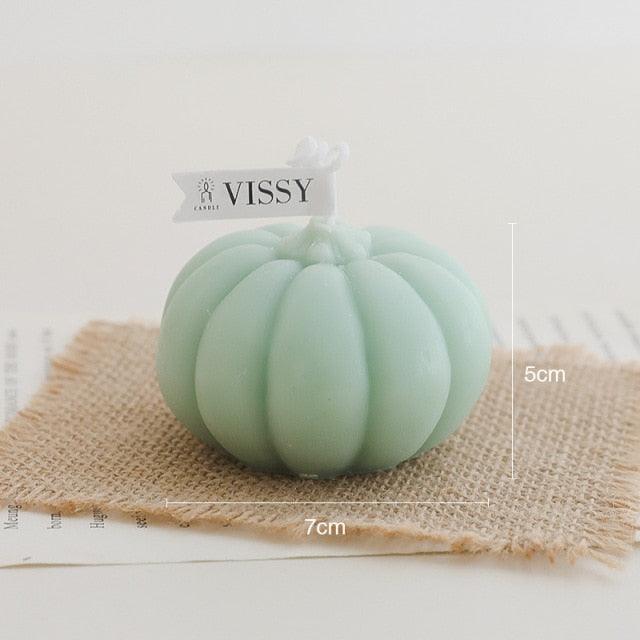 Light green pumpkin-shaped candle on burlap with VISSY label