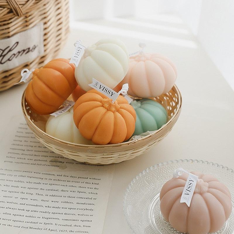 Pumpkin-shaped handmade aromatherapy candle set in orange, peach, white, and mint-green