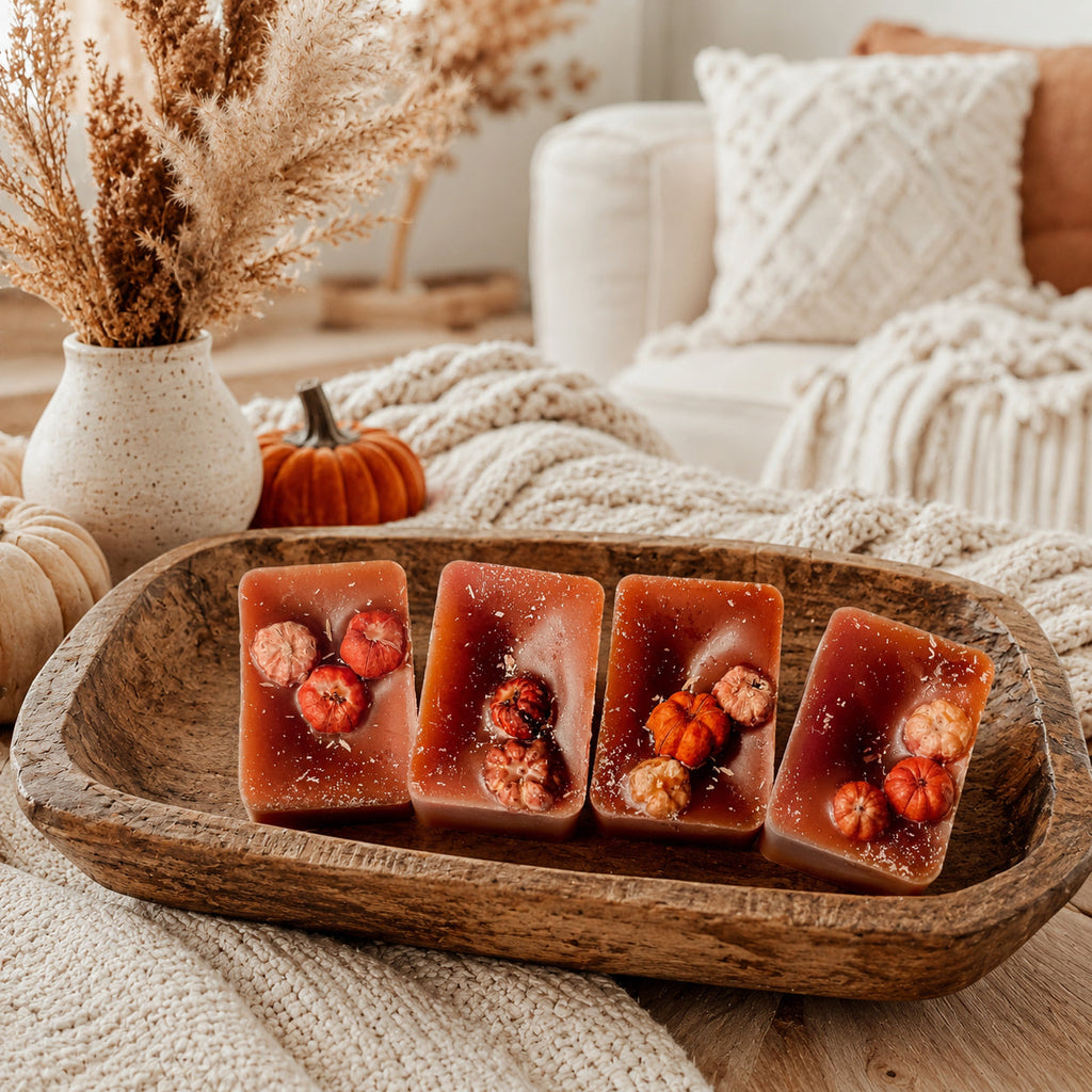 XL pumpkin pecan wax melt squares on a wooden dish, dark amber with embedded nuts.