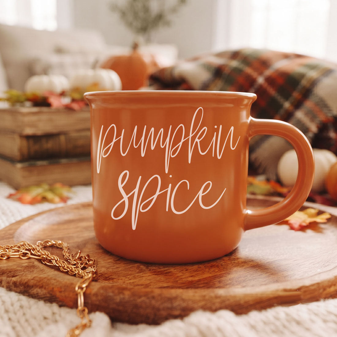 Orange ceramic mug with “Pumpkin Spice” script text and side handle