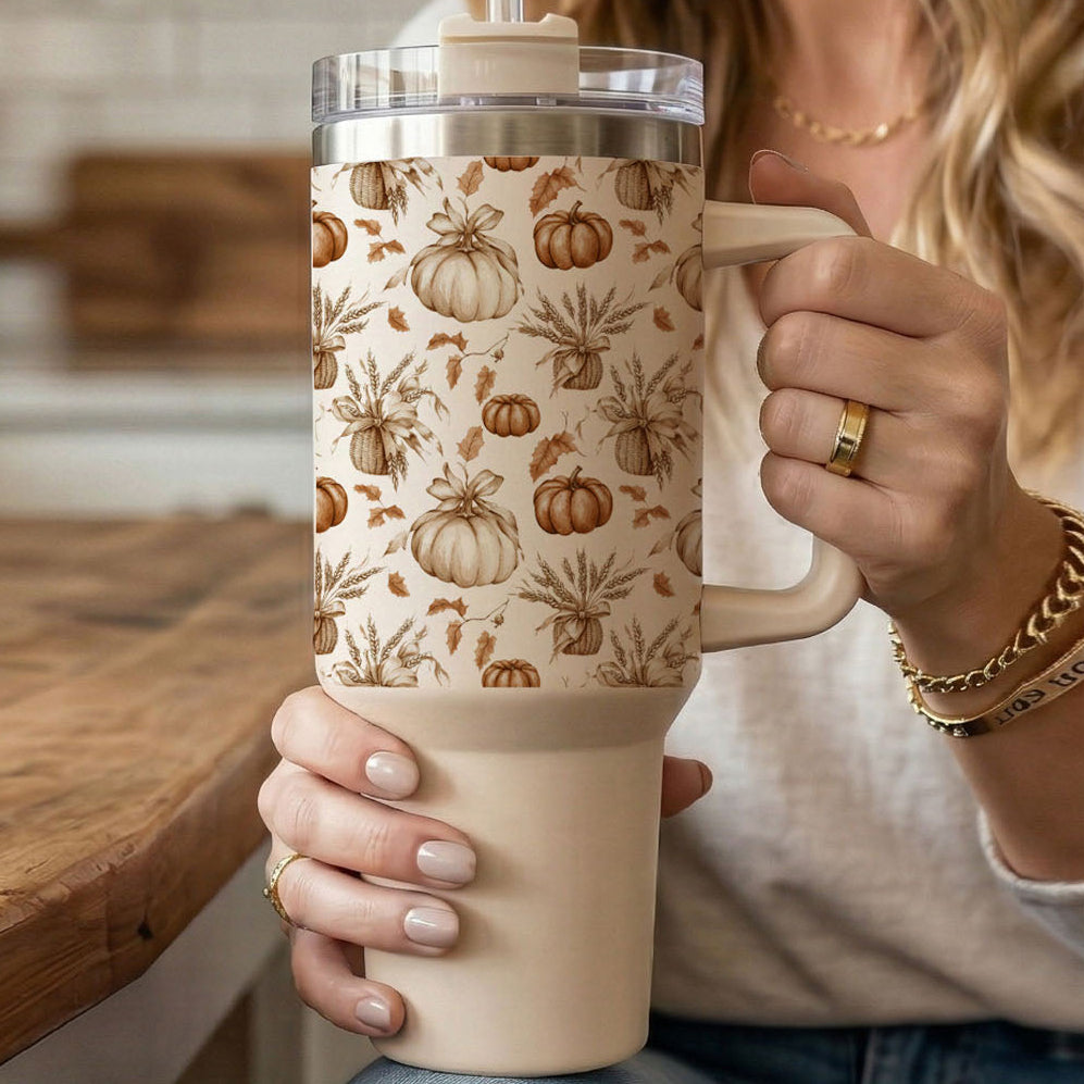 40 oz tumbler with pumpkin and leaf print, clear lid, and beige handle base