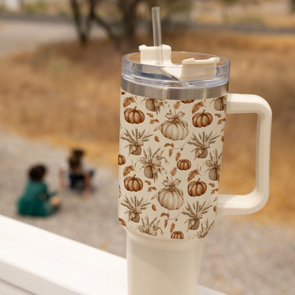 Beige travel mug with handle, clear lid, straw, and pumpkin spice botanical pattern.