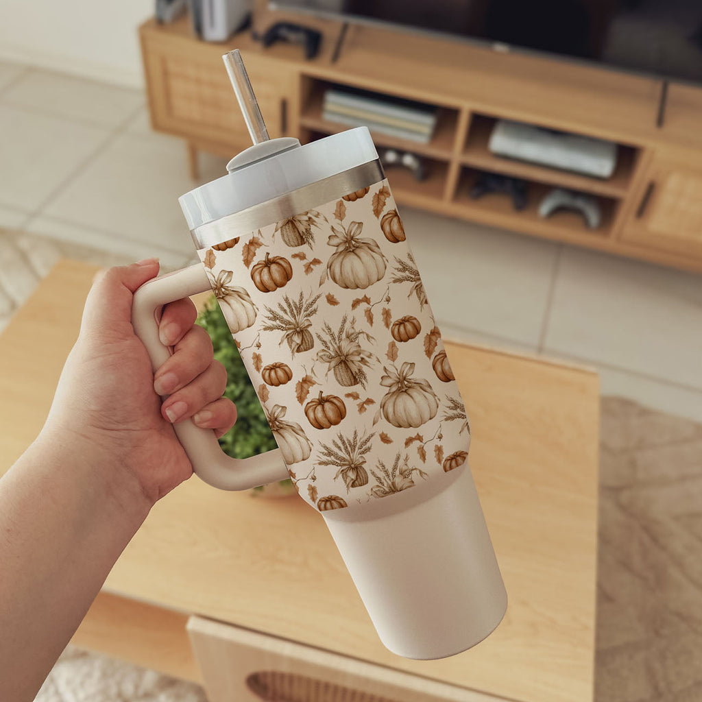 Beige travel tumbler with handle, clear lid, straw, and pumpkin botanical print.