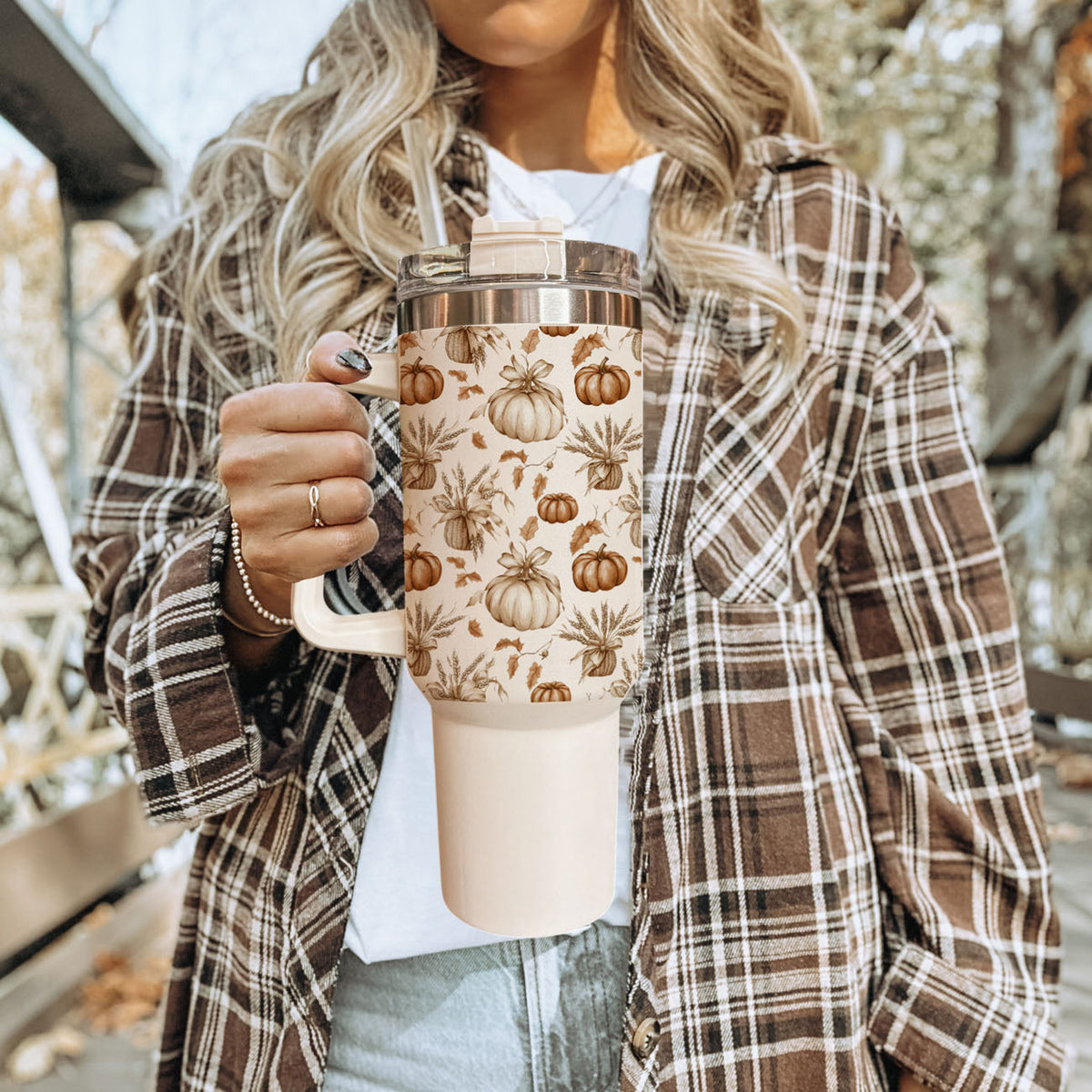 Beige insulated tumbler with clear lid, straw, and rustic pumpkins and herbs design.
