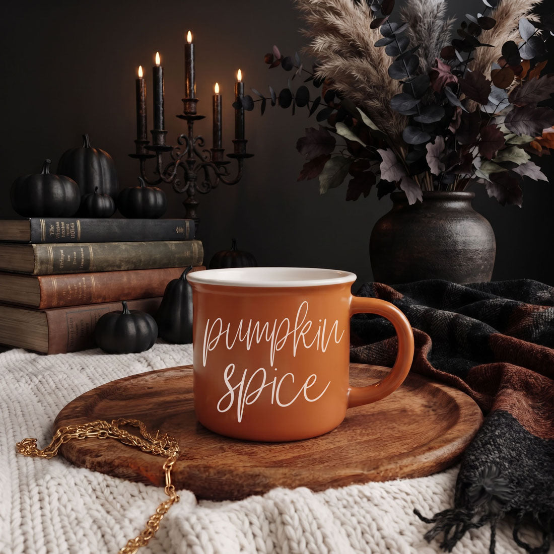 Orange ceramic mug with white cursive pumpkin spice lettering, side handle