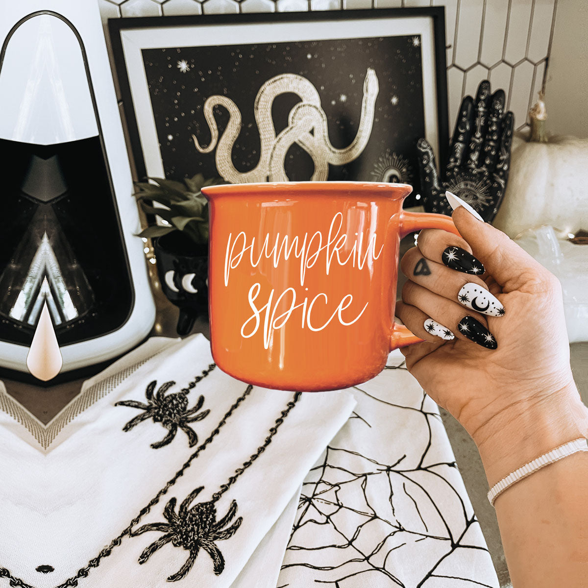 Orange ceramic mug with handle and Pumpkin Spice script lettering