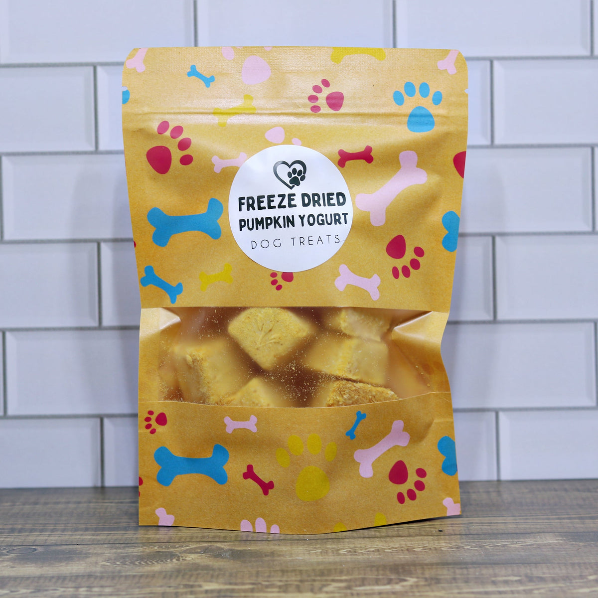 Freeze-dried pumpkin yogurt dog treats in yellow stand-up pouch with paw print design
