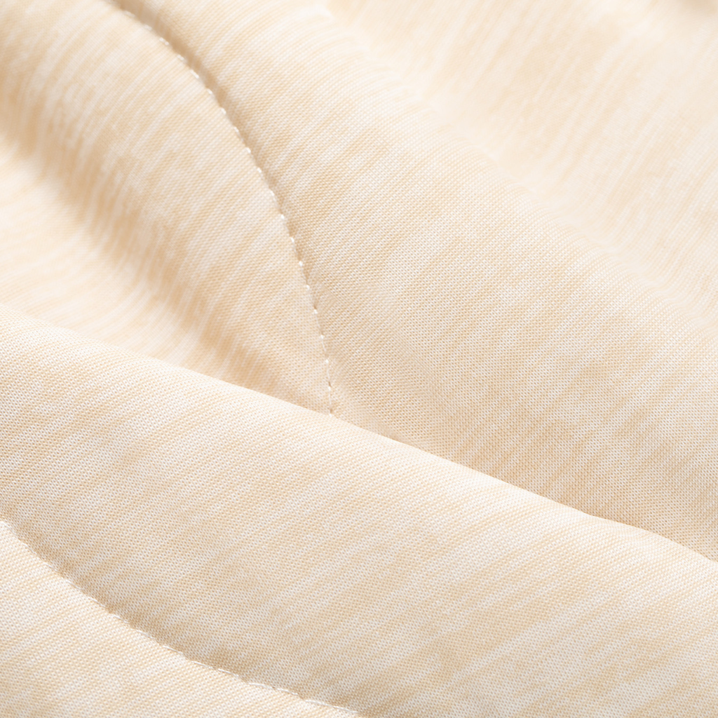 Cream quilted pet blanket close-up, stitched panel and seam detail