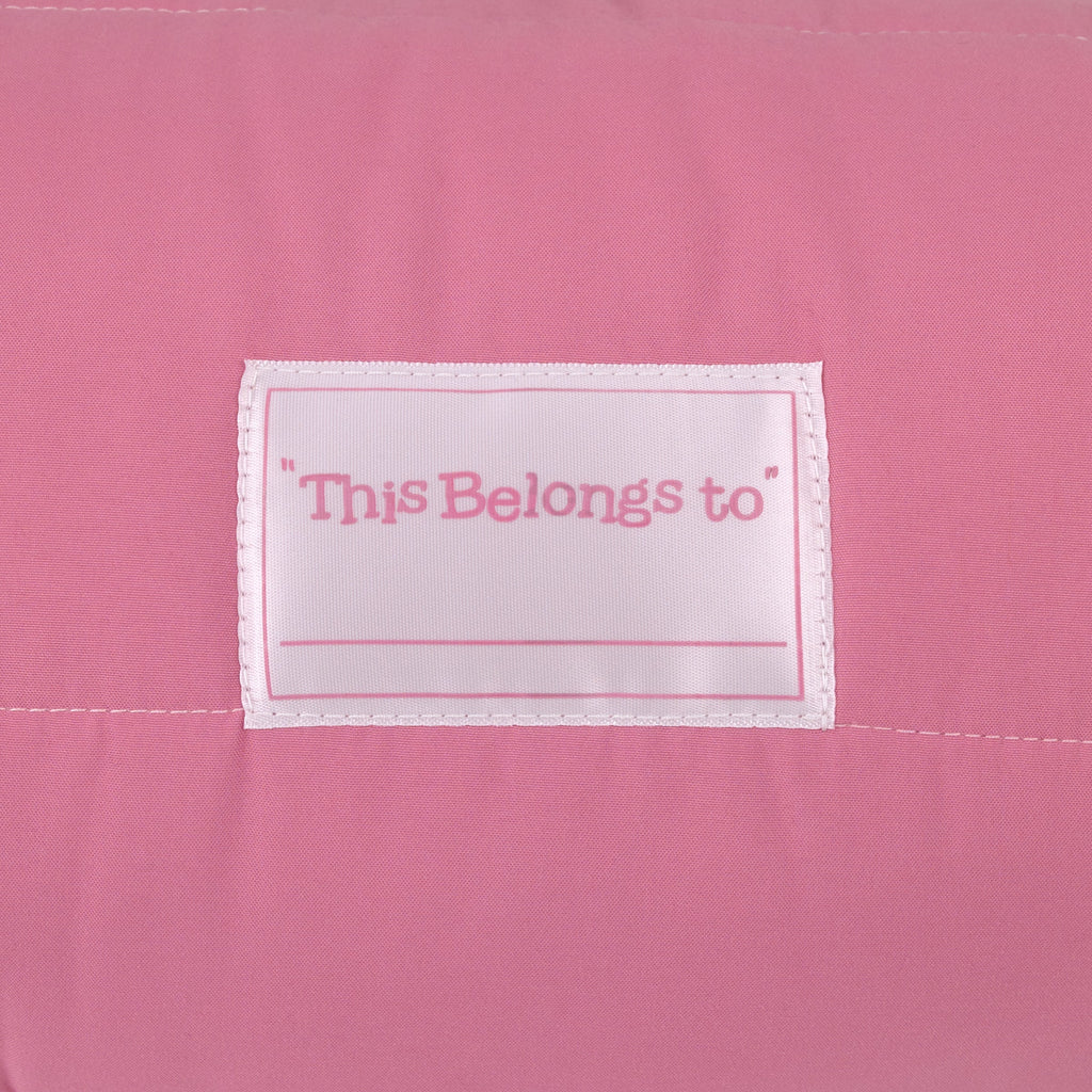 Toddler nap mat pink fabric with stitched name label reading “This Belongs to”