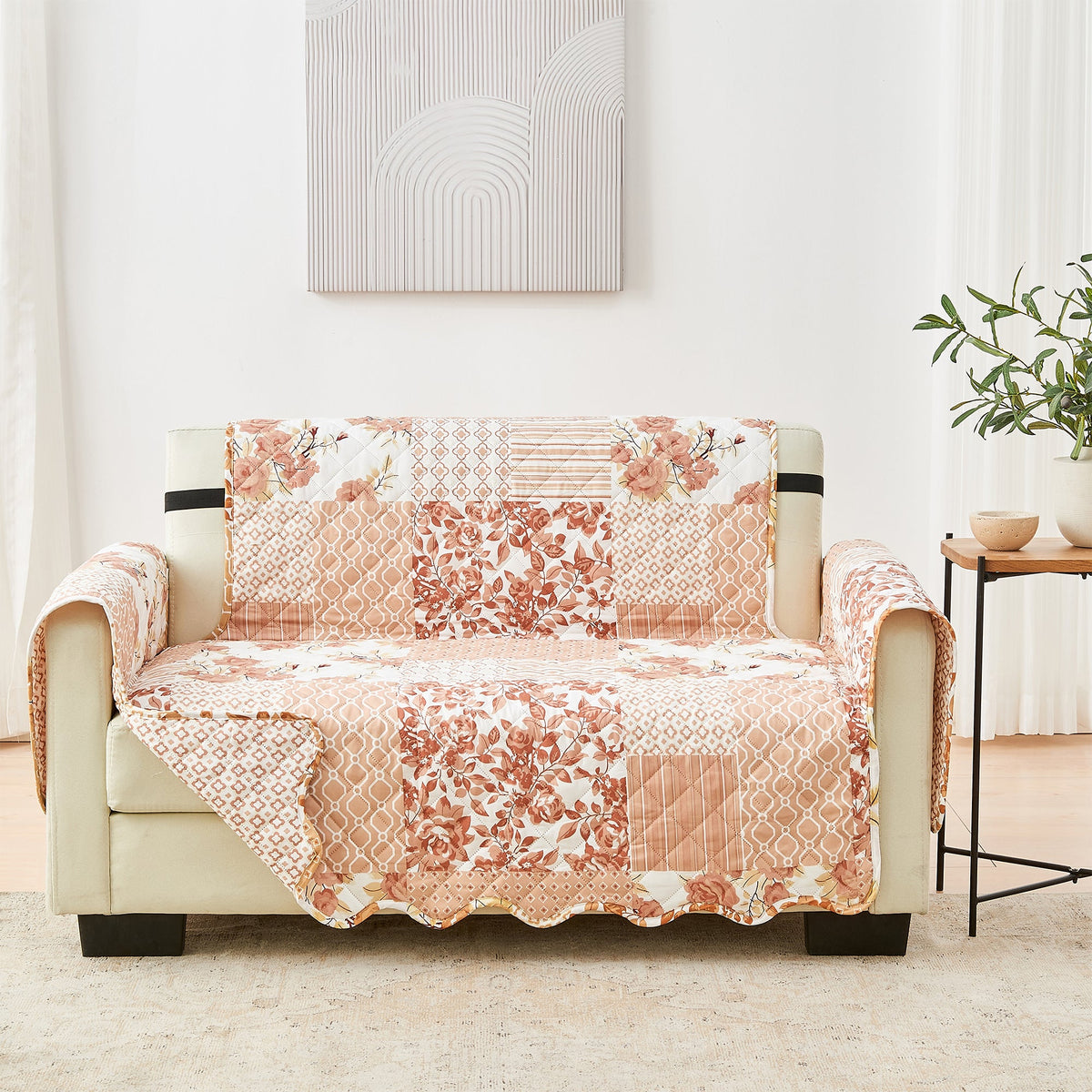 Reversible loveseat protector in peach floral and lattice patchwork, quilted with fitted sides