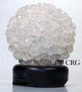 Tumbled quartz lamp with clear crystal cluster on dark wood base