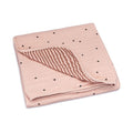 Blush muslin quilt with dot print and striped reversible layer