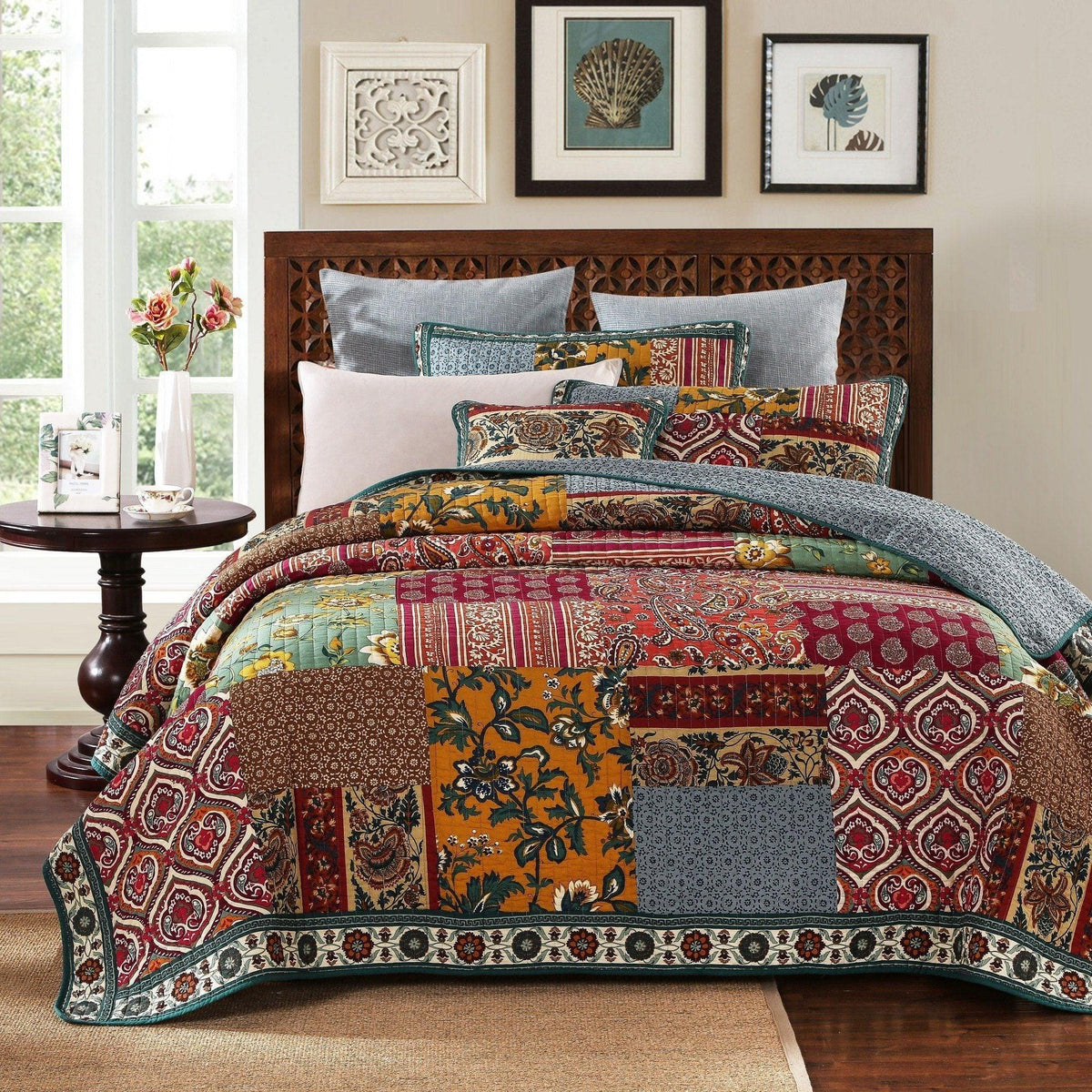 Bohemian floral cotton patchwork bedspread set layered on a bed with matching pillows