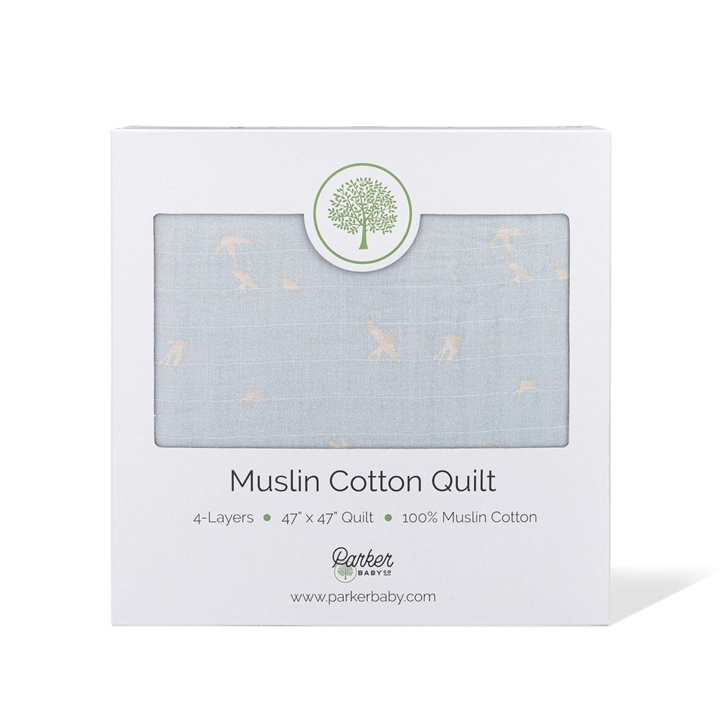 Light blue muslin cotton quilt gift box showing folded quilt through window
