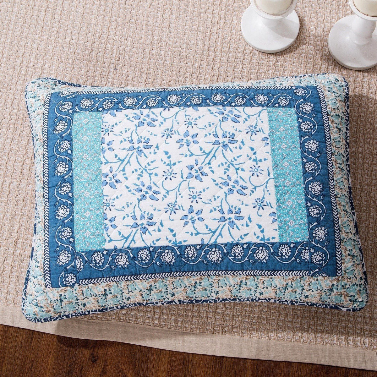 Decorative pillow sham in blue and white patchwork floral geometric border