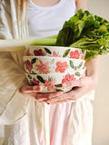 Porcelain salad bowl stack with hand-painted pink and red floral design, held in hands