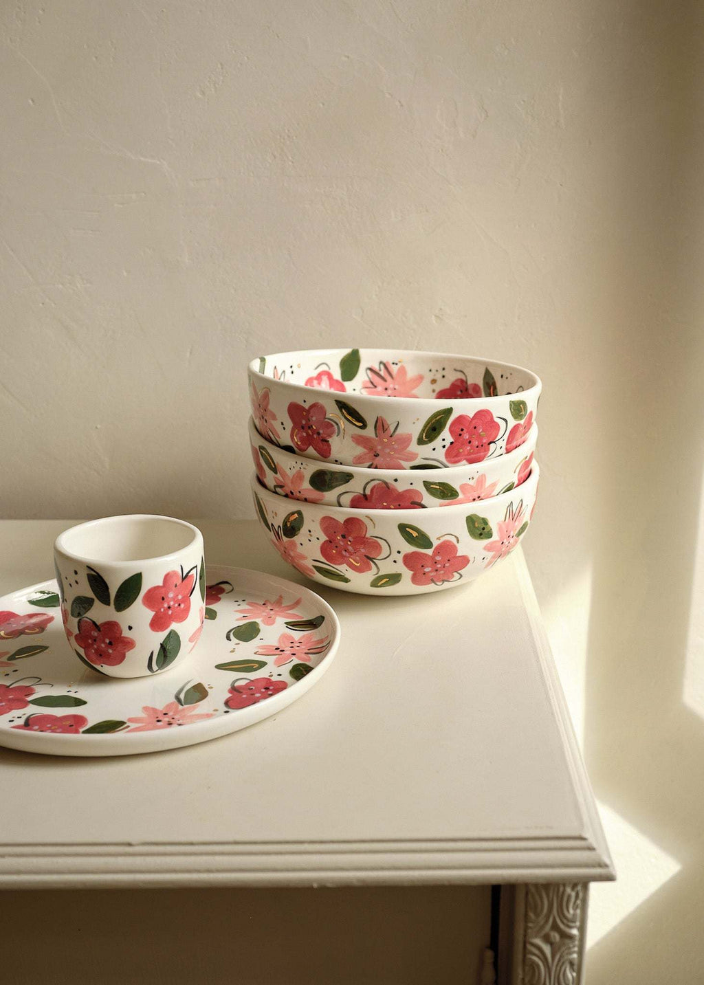 Stacked white porcelain salad bowls with hand-painted pink and red floral pattern