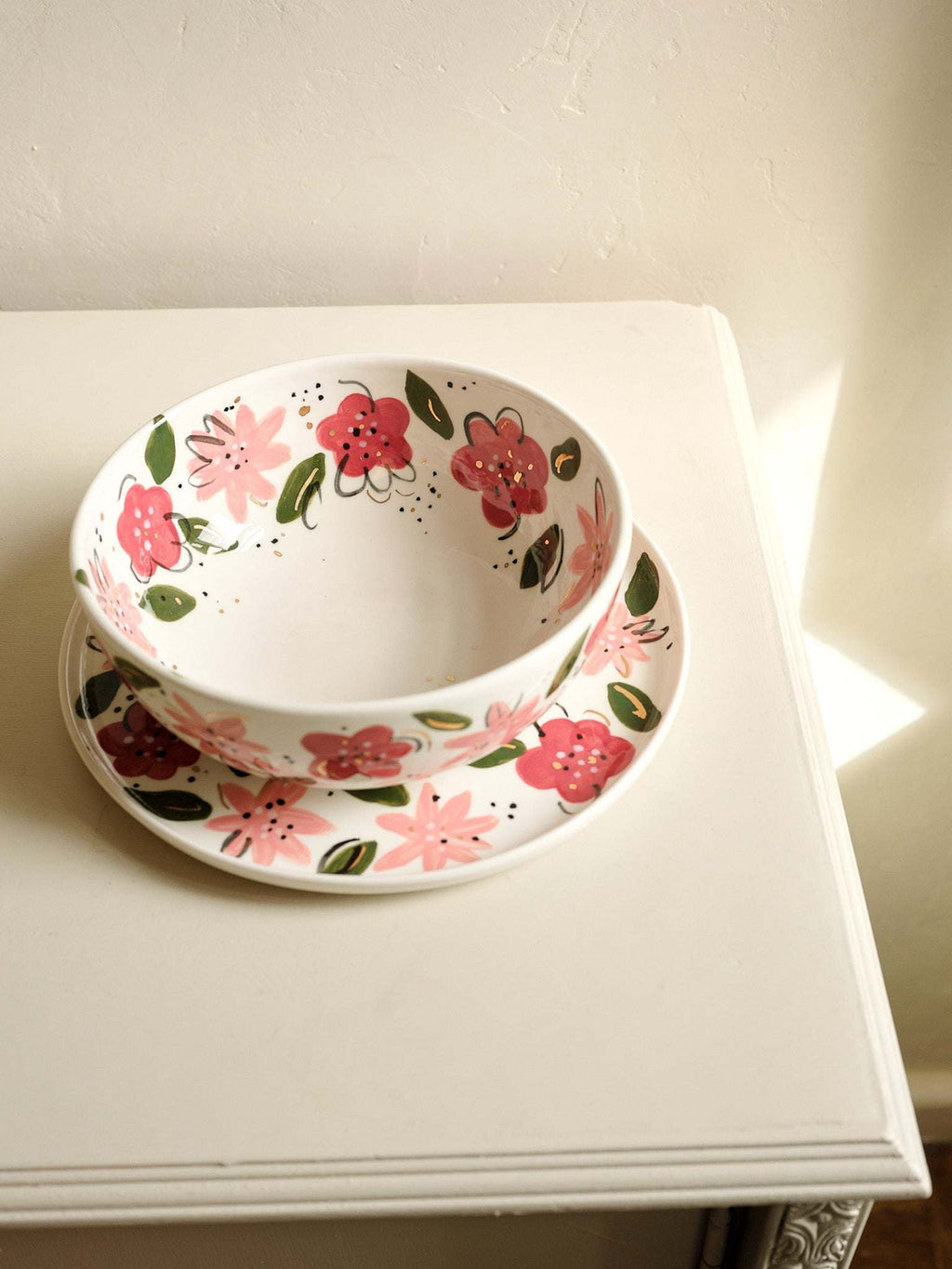 White porcelain salad bowl with hand-painted pink, coral, and red flowers and leaves