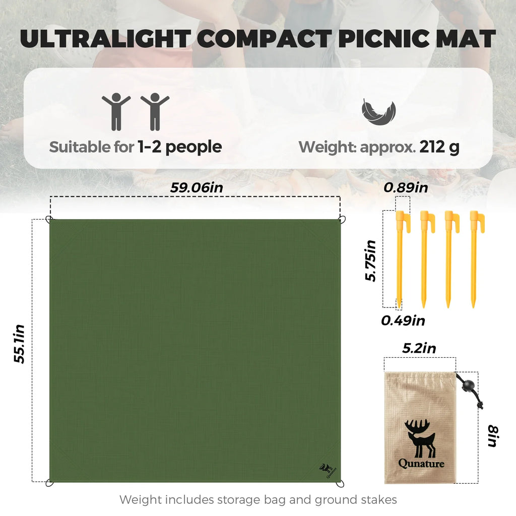 Green compact picnic mat laid flat with dimensions and included stakes