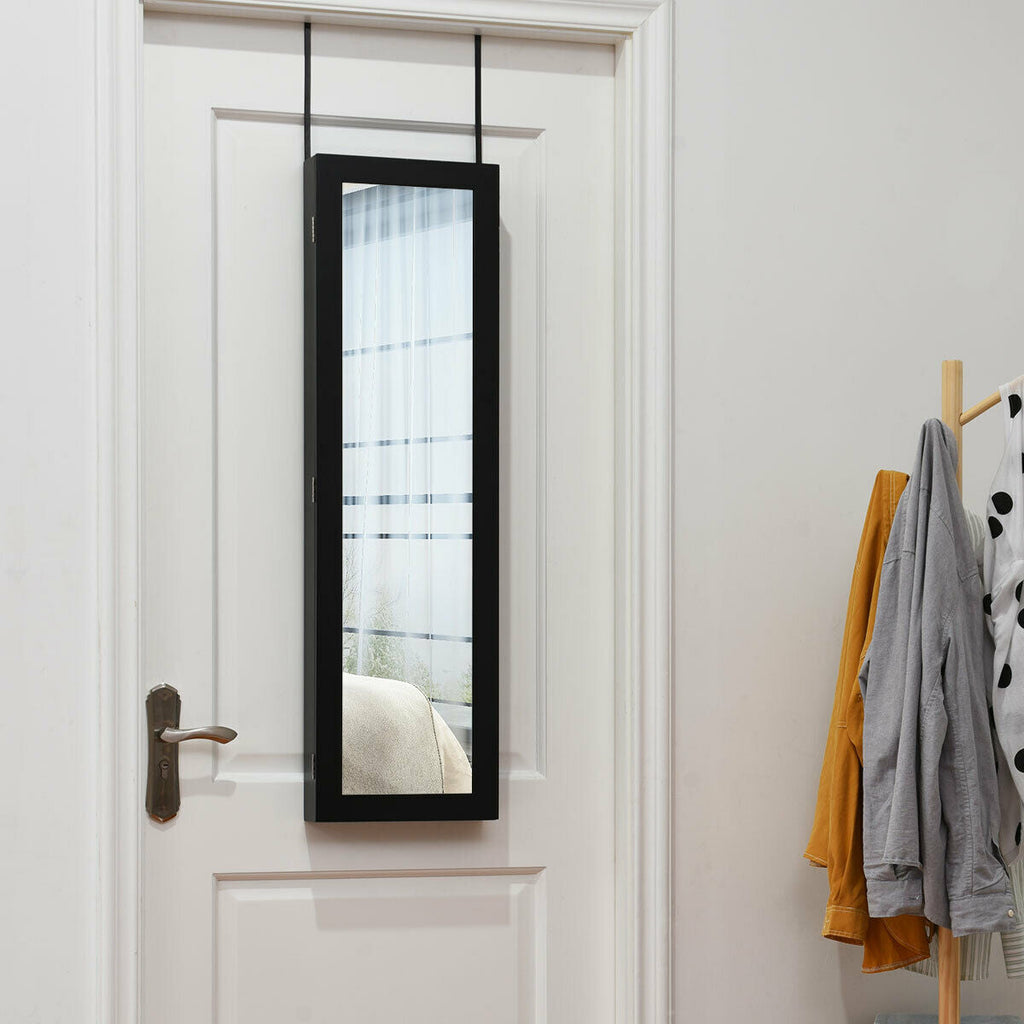 Full length mirror jewelry cabinet with black frame hanging on a door, interior storage visible