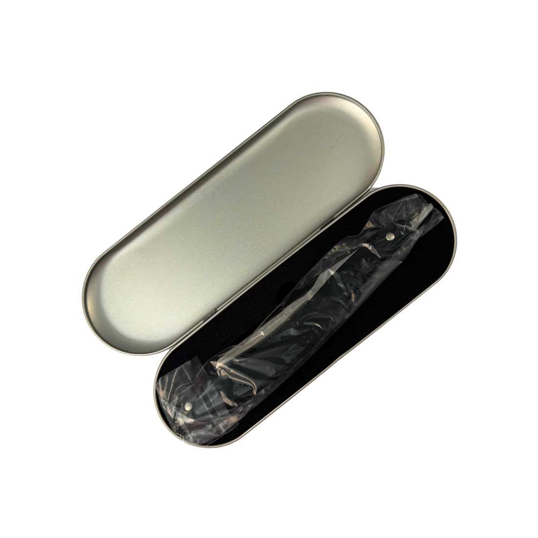 Opened silver razor case with black interior and wrapped razor