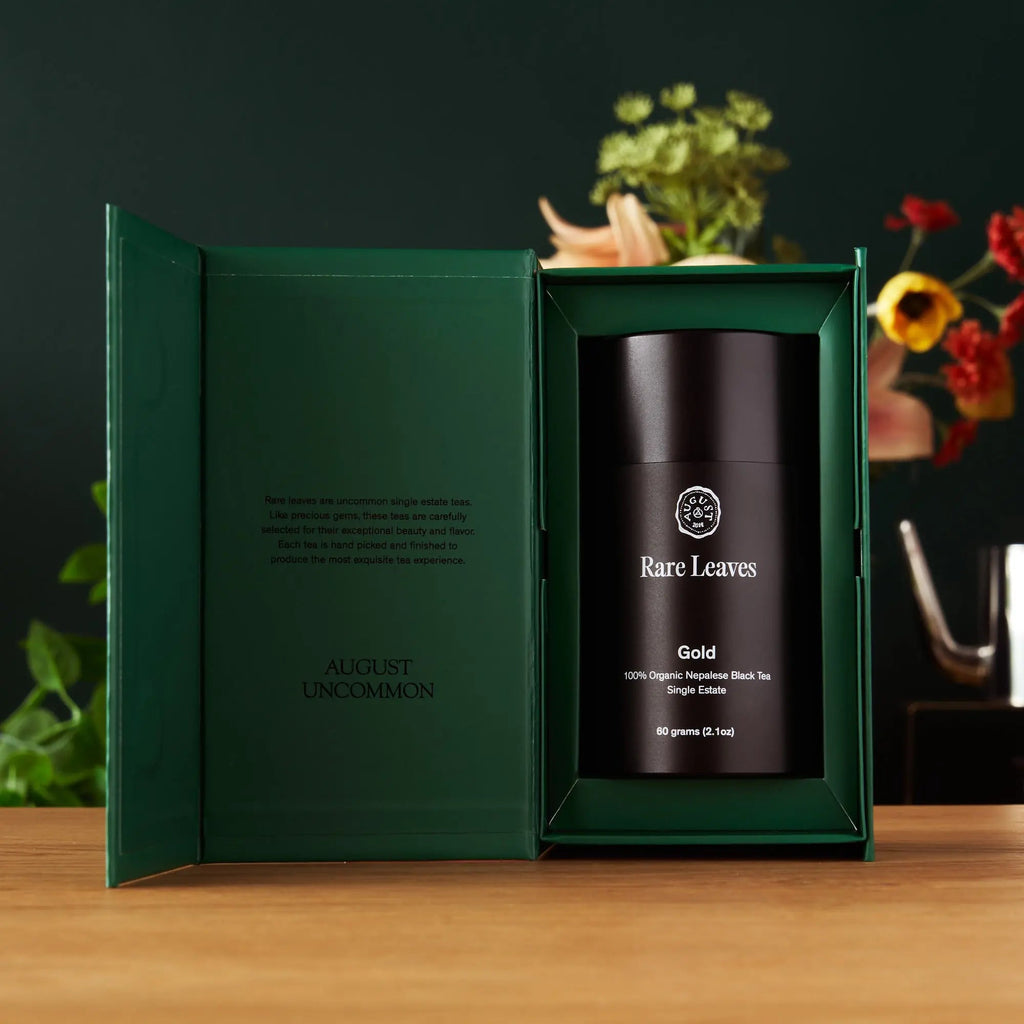 Gold tea gift box open, showing a dark canister labeled Gold