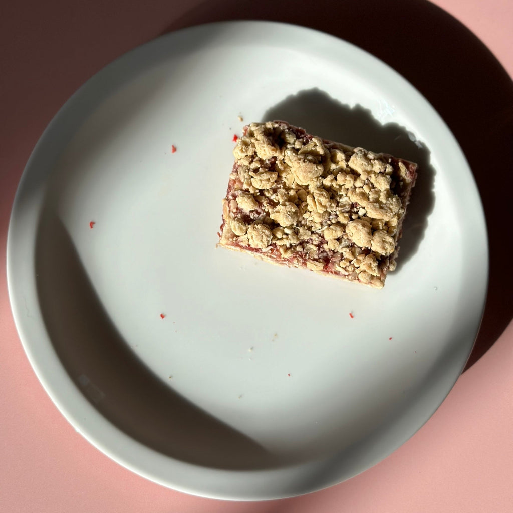 Raspberry oat bar on white plate