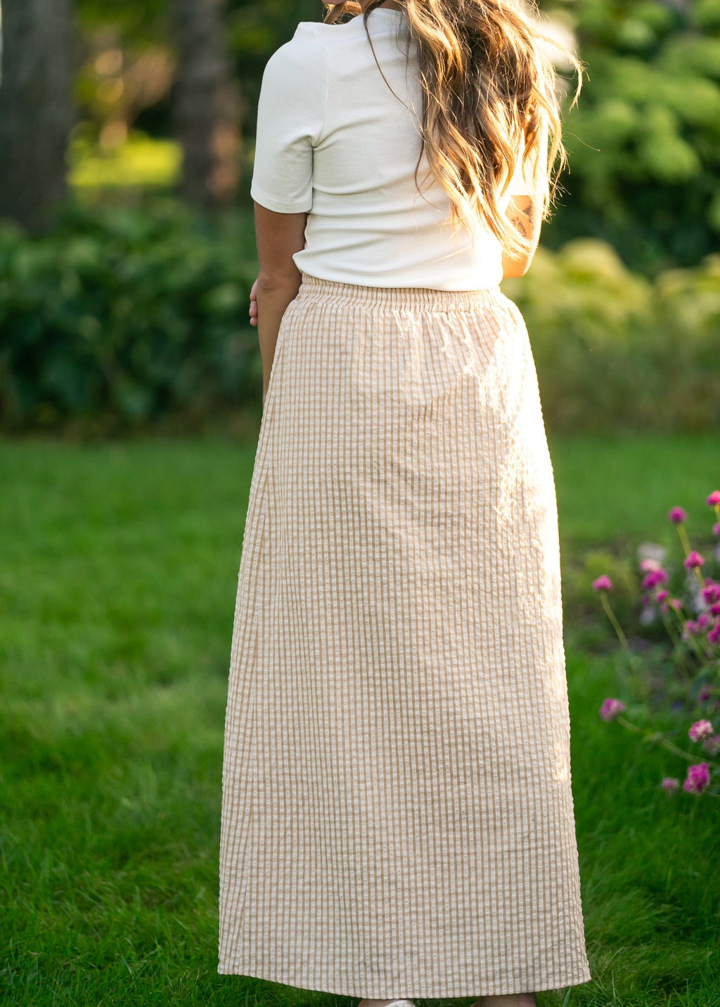Rear view: light beige and white gingham maxi skirt with elastic waist and full drape
