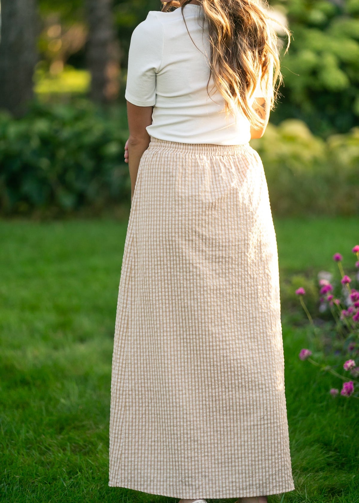 Rear view: light beige and white gingham maxi skirt with elastic waist and full drape