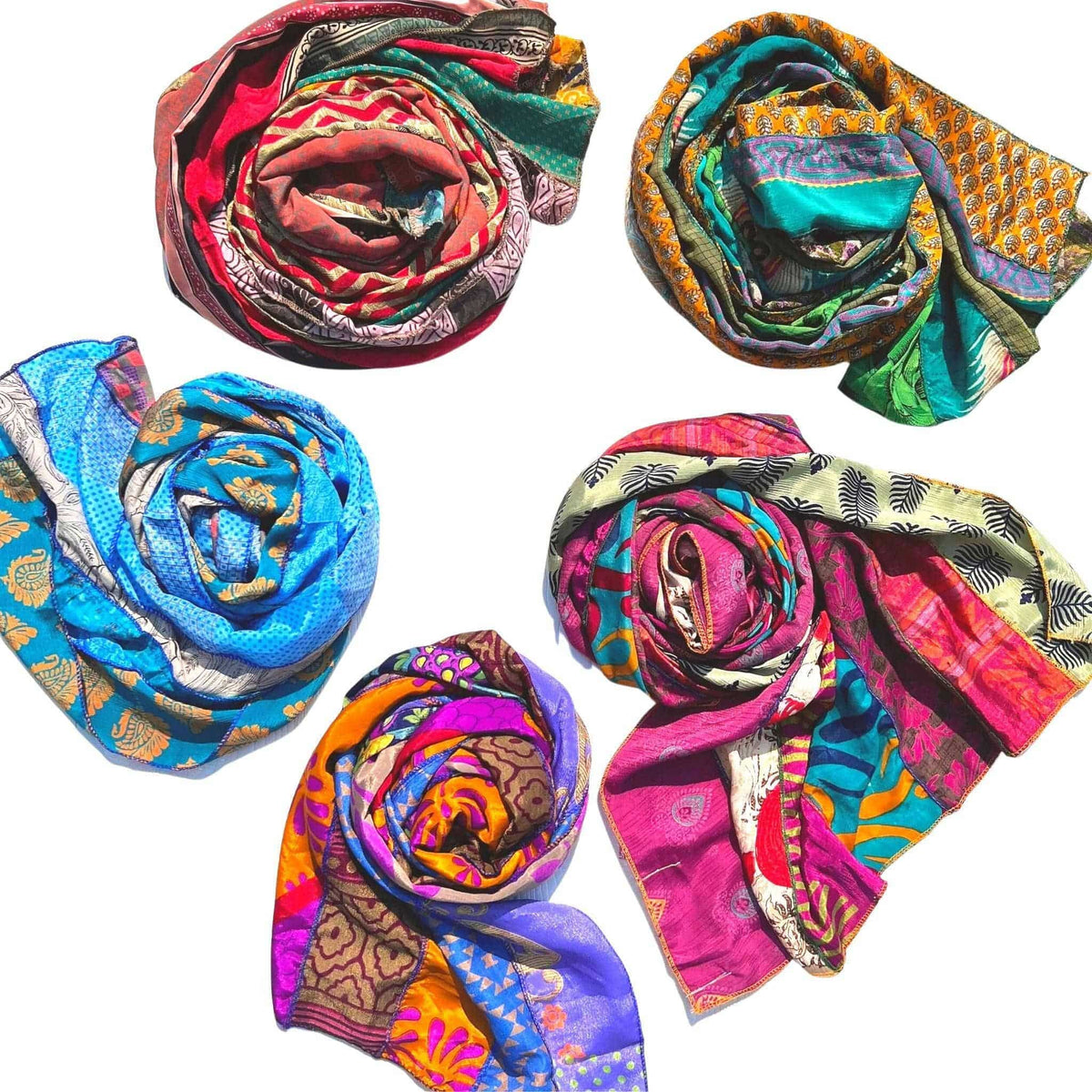Set of multicolor patterned sari patchwork scarves, rolled and fanned out.