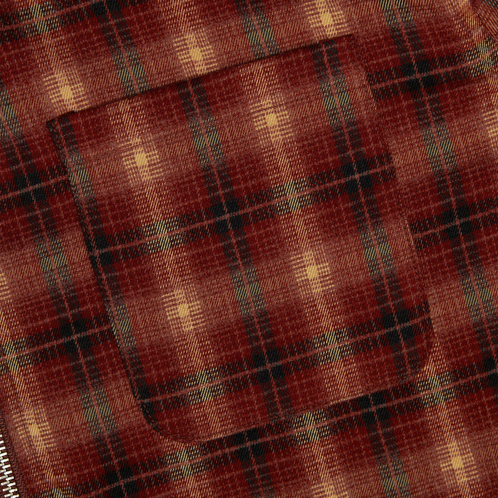 Red and tan plaid flannel zip-up jacket fabric close-up