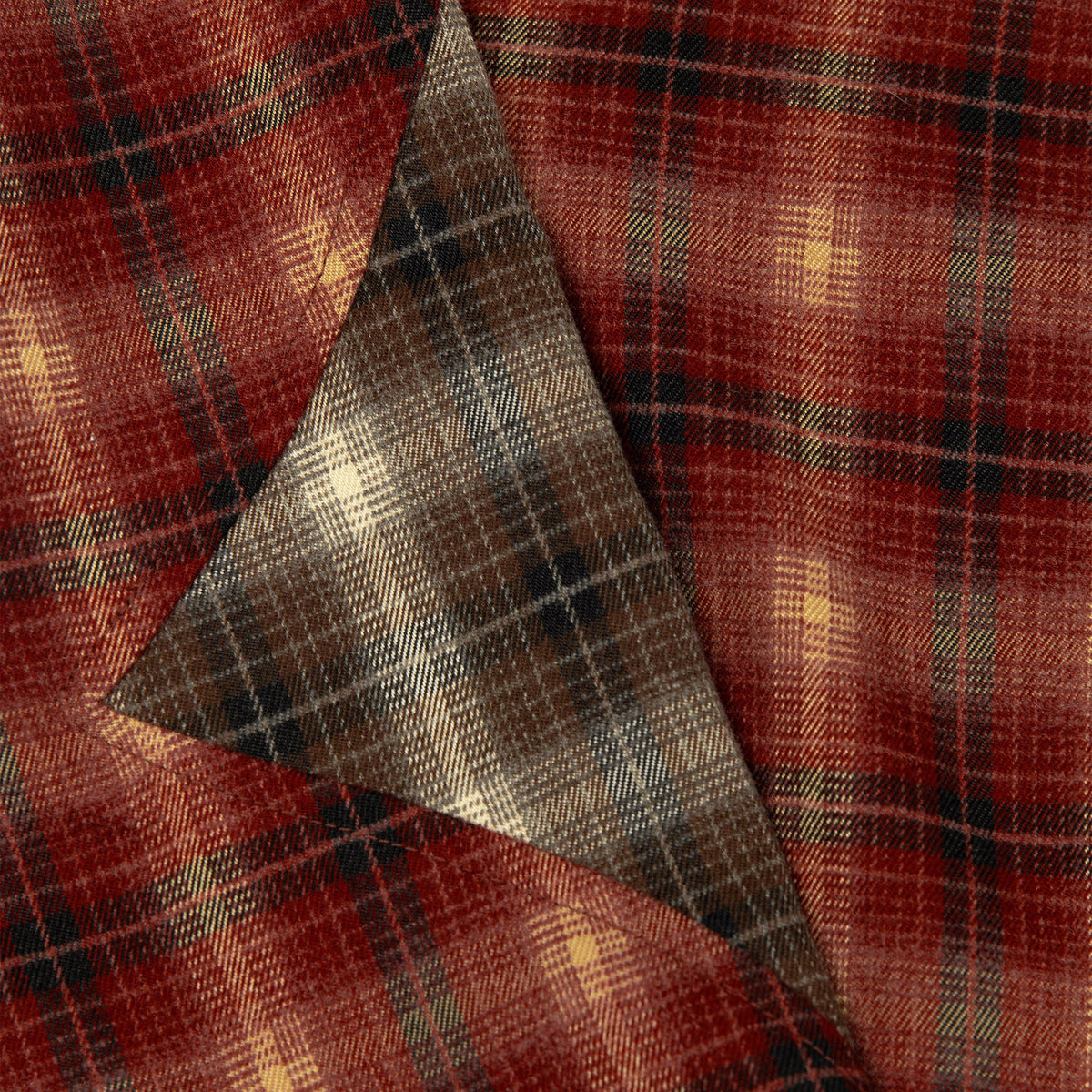 Close-up of plaid flannel interior panel in tan, gray, and dark tones