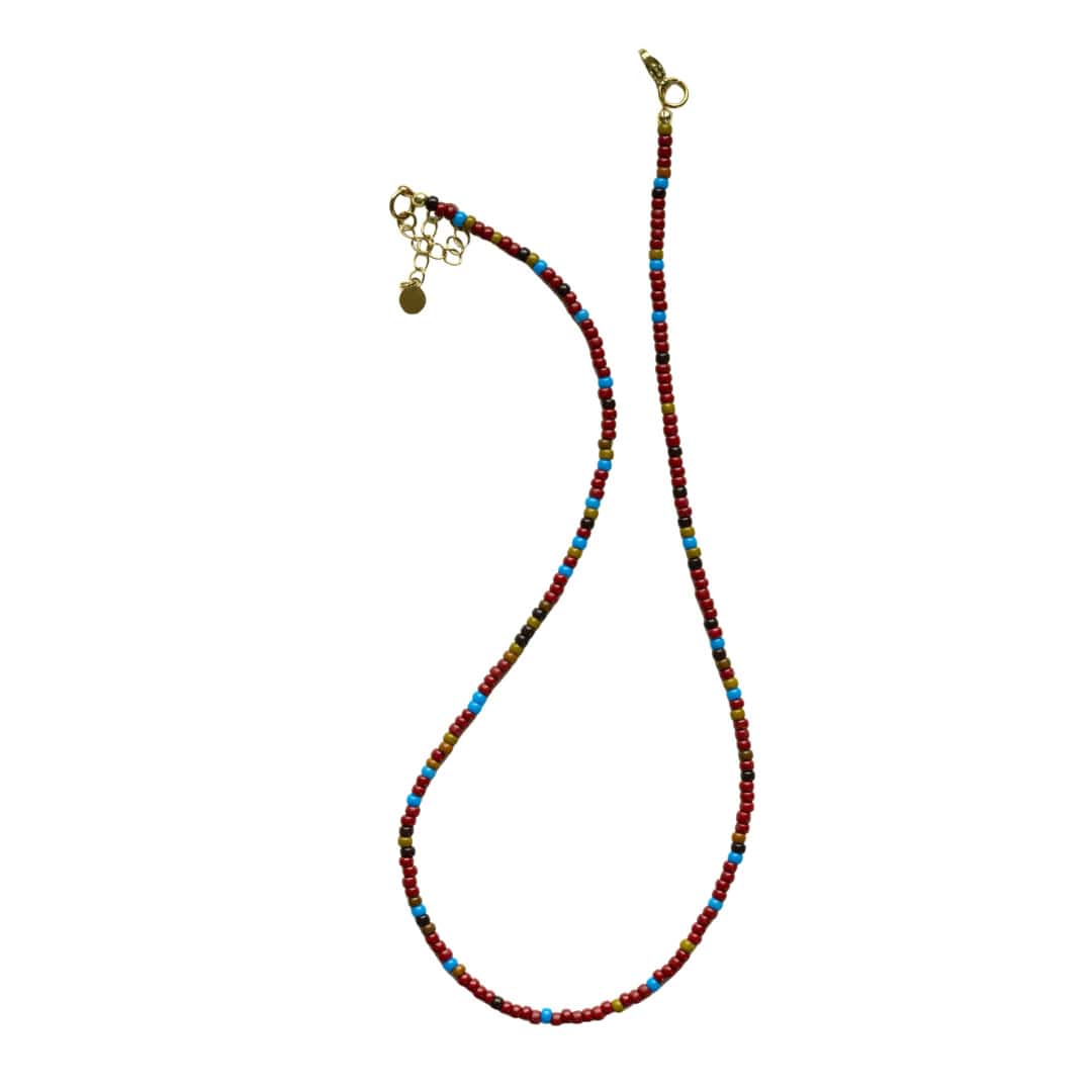 Multicolor seed-bead necklace with gold clasp and small dangling charms.