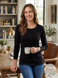 Black crewneck sweater with studded cuffs