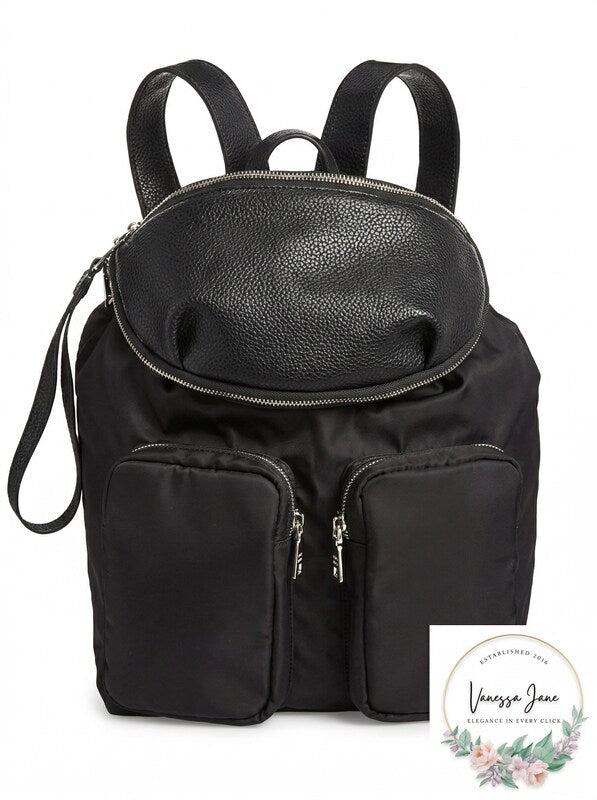 Black Steve Madden boomer backpack with two front zipper pockets and top handle