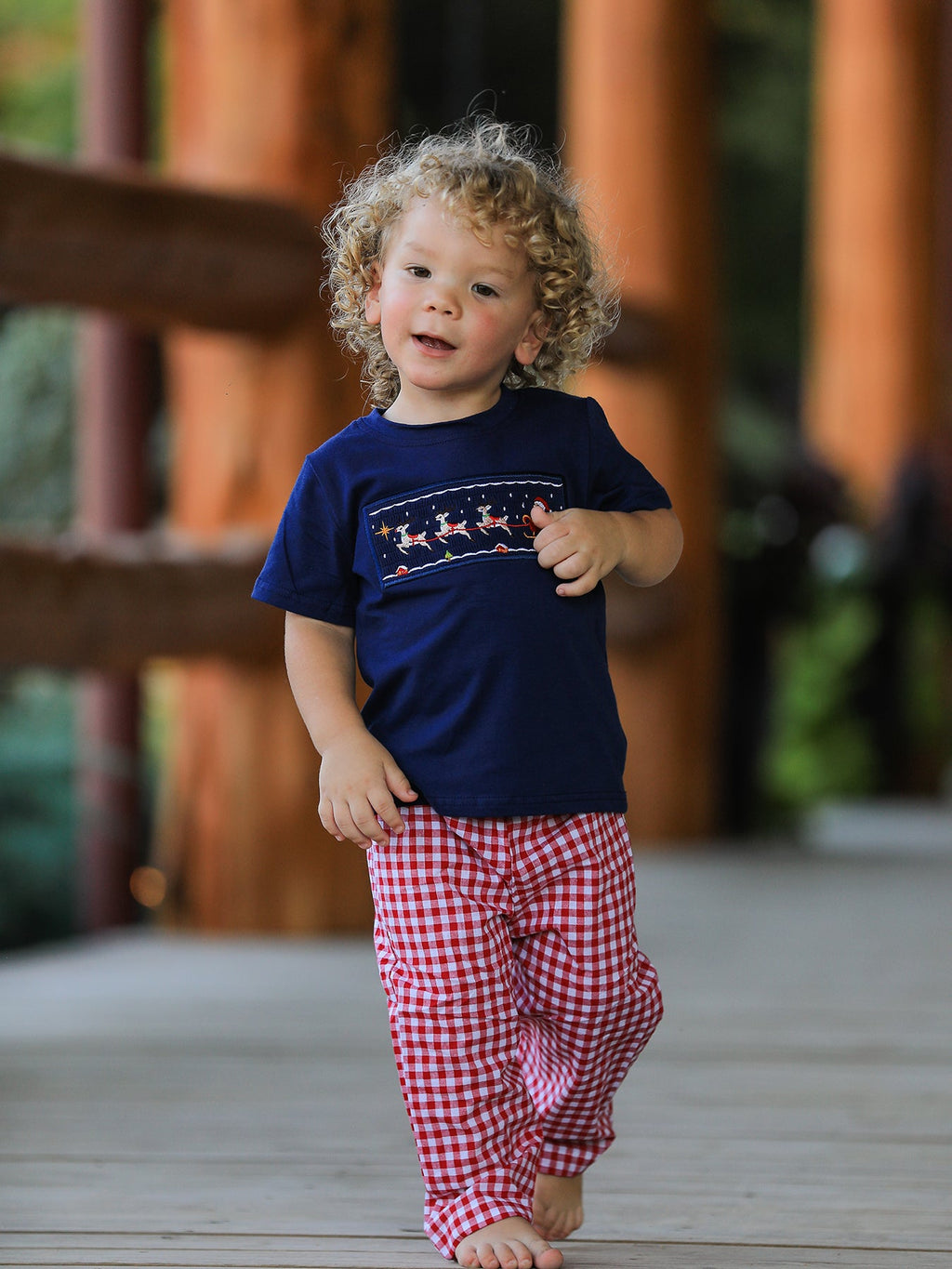 Boys navy T-shirt and red plaid pajama pants set with festive Santa sleigh graphic