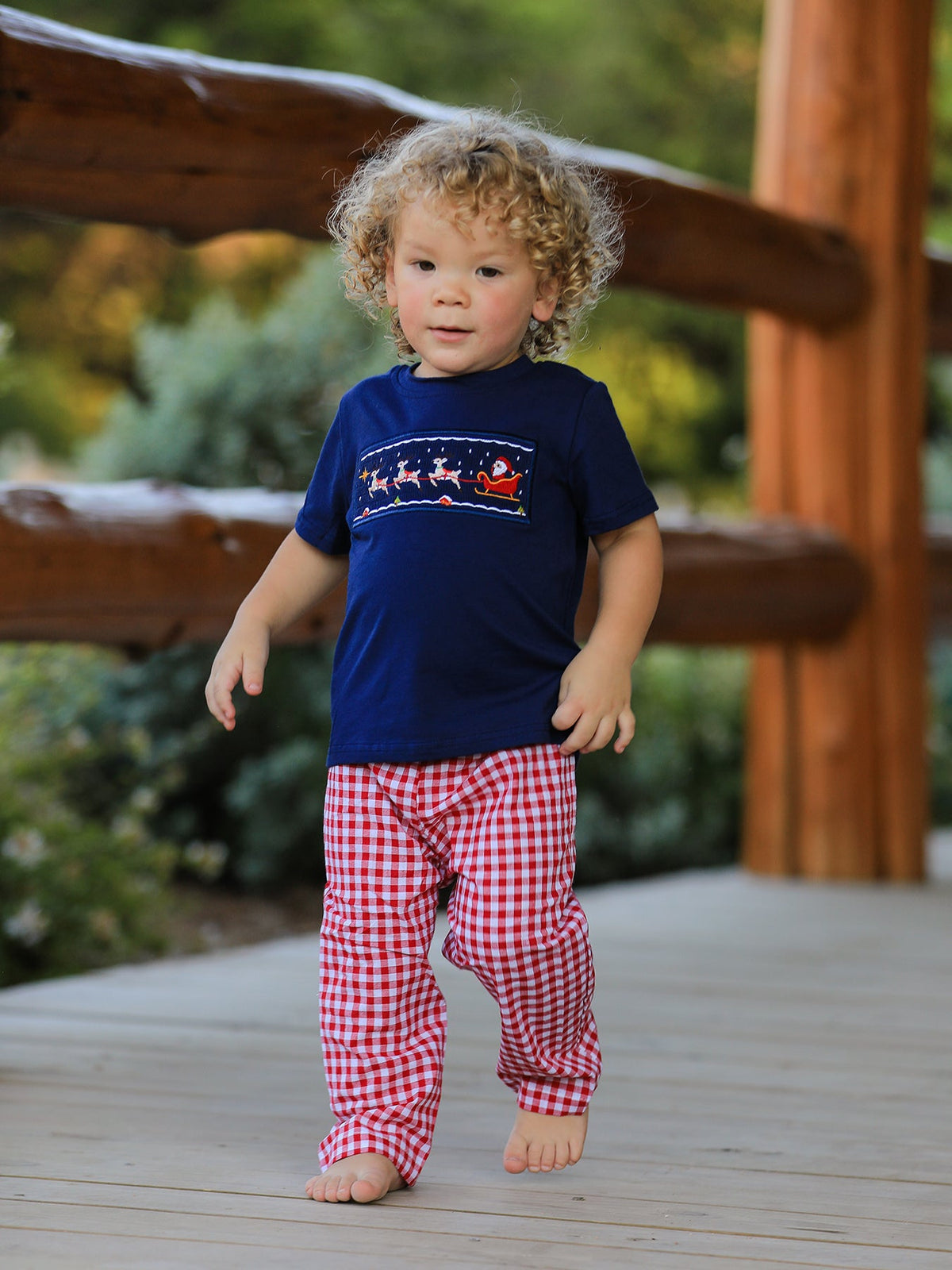 Baby boys navy T-shirt and red plaid pants set featuring Santa sleigh holiday graphic