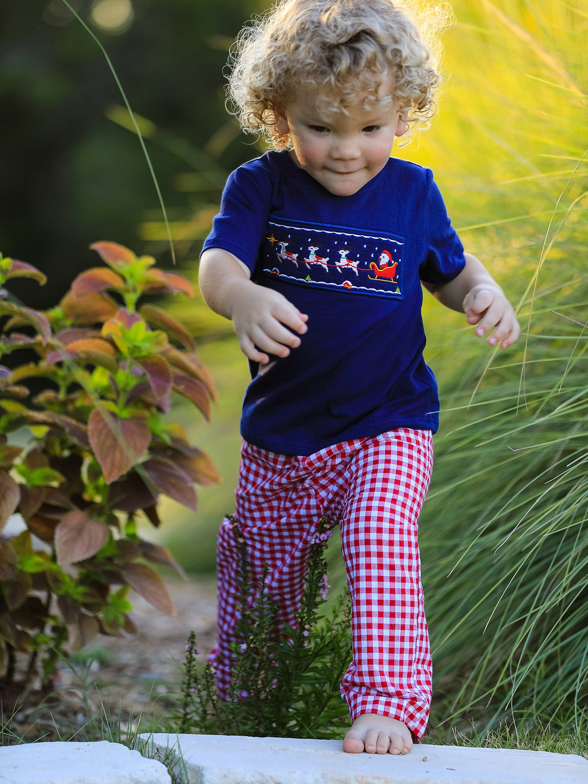 Boys navy T-shirt and red plaid pants set with Santa sleigh graphic and cuffed hems