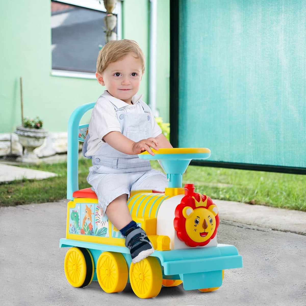 Electric ride-on train toy with lion face and seated toddler outdoors