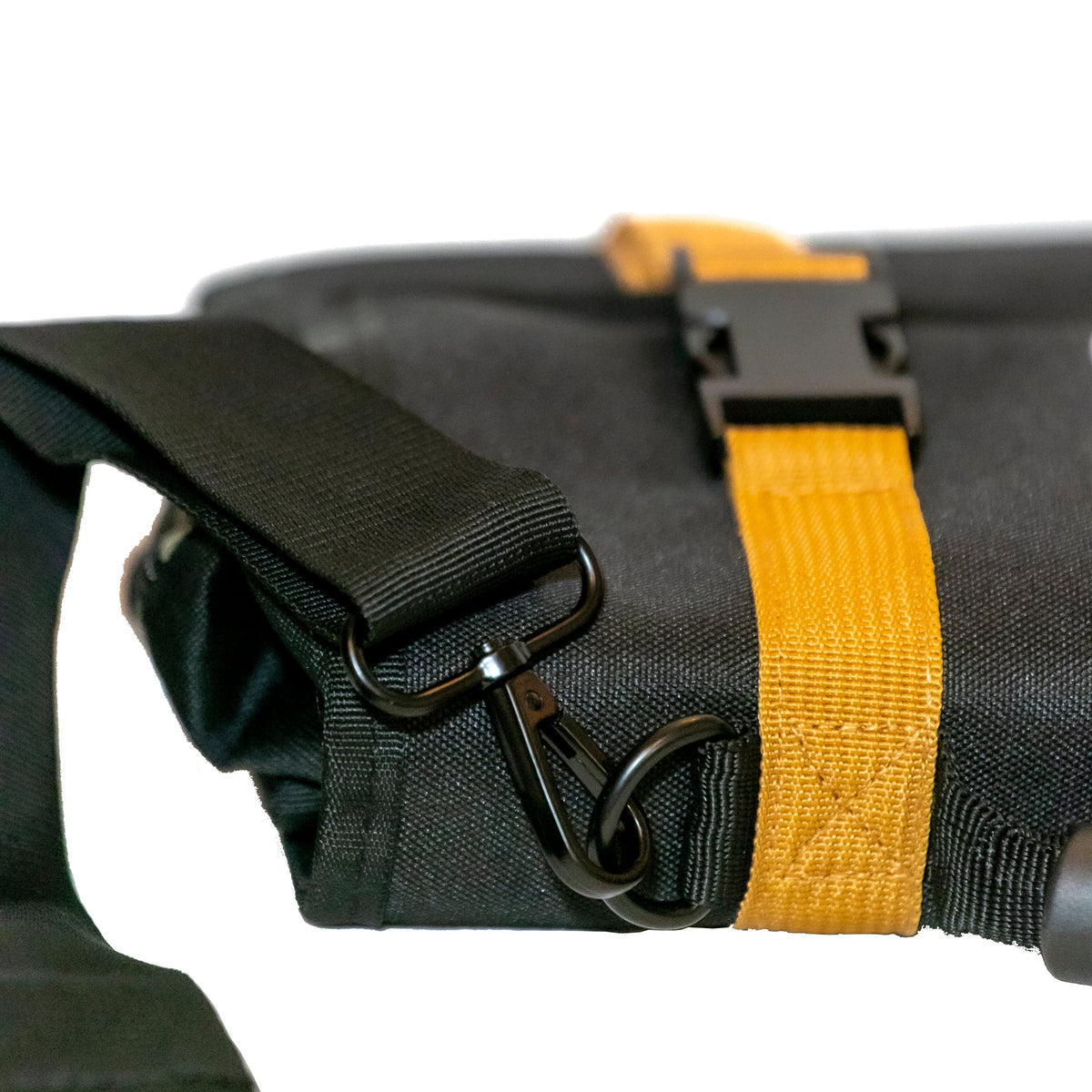 Close-up of RiPouch Gear Roll strap with black buckle and tan webbing