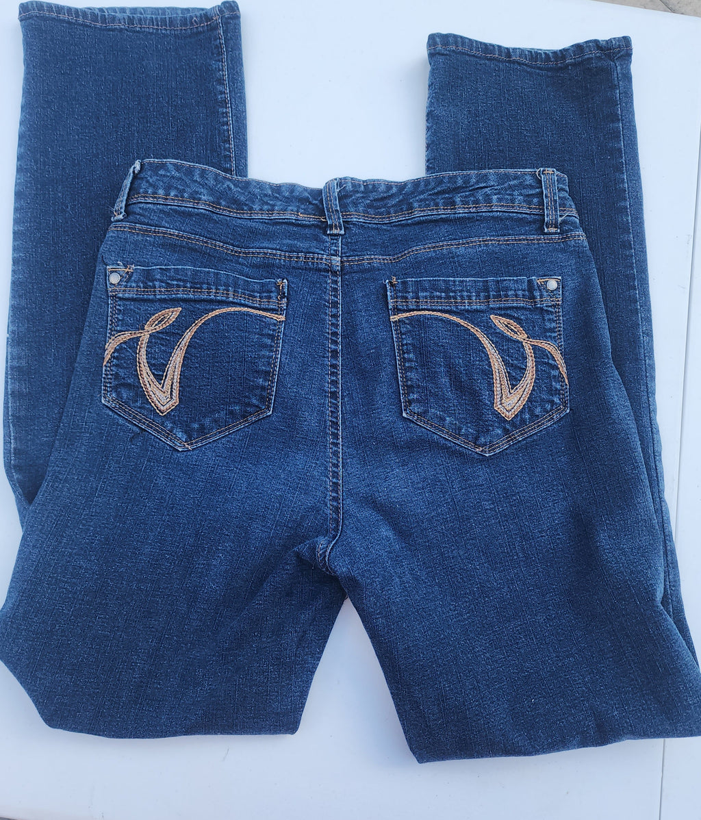Women's blue jeans laid flat, embroidered back pockets, button-front style