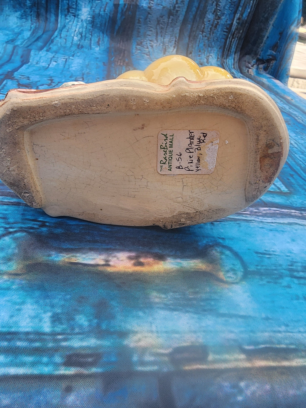 Ceramic planter underside with molded base and small label sticker