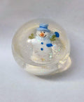 Snowman snow globe with blue hat and scarf inside clear glass globe